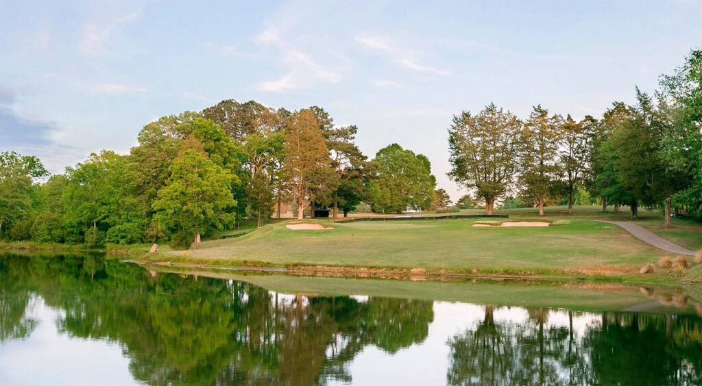 A landscape shot at the edge of the pond at Spring Lake Golf Club with a course hole visible